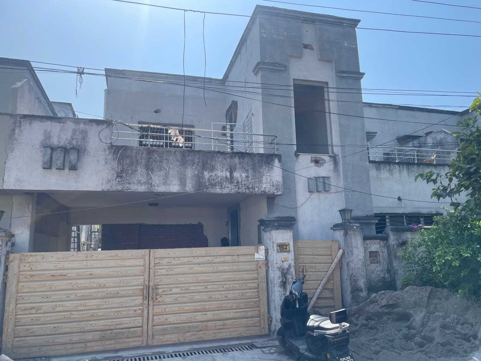 Front of House #162 in Askari 2, with new wooden gates and building sand outside