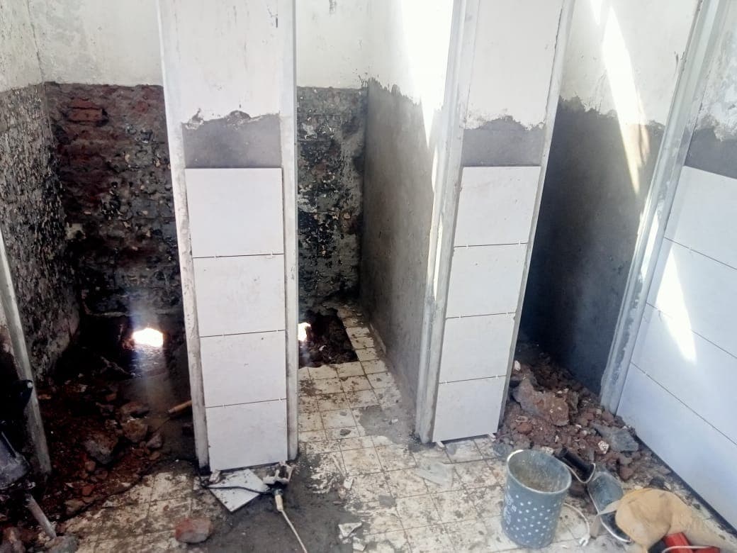 White wall tiles going up around a bathroom being rebuilt